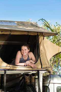 teen girl inside a roof top camping tent