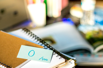 0 Percent; Stack of Documents and Laptop at working Desk.