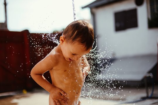 Boy is playing with the water
