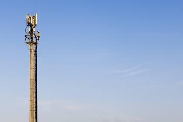 A large cellular communication station on a blue sky background