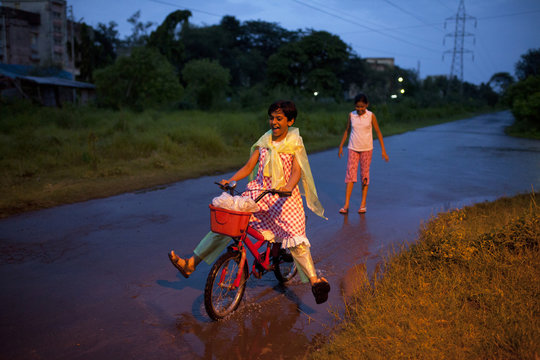 Teenage girl plying with cycle in blue hour
