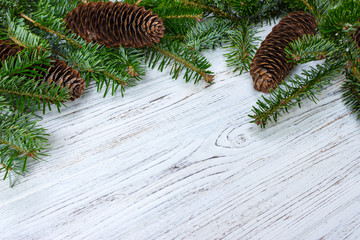 Christmas background. Fir tree branch pine cones at wooden table. Flat lay, space for text