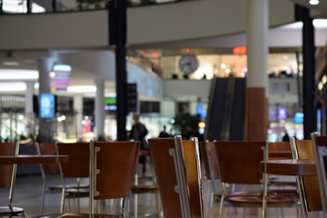 Empty shopping mall cafe. Focus on foreground, background blurred defocused.