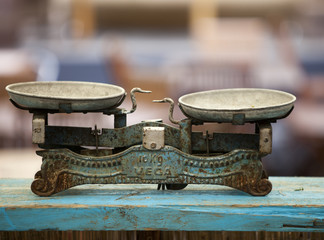 Antique vintage balance old scales on a wooden surface..