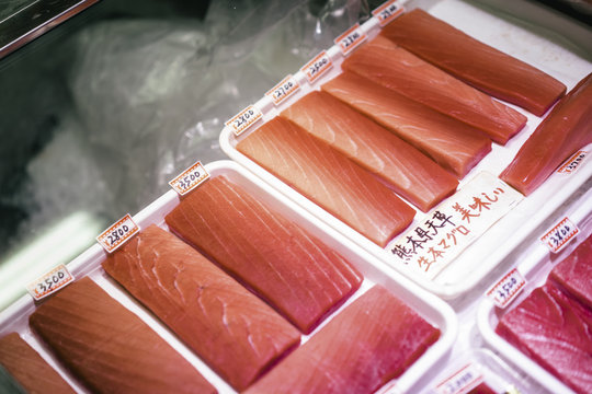 Small pieces of filleted tuna with  Japanese price tags