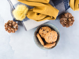 Home winter relax with woolen plaid and chocolate chip cookies. Time for cozy blanket sweater sweet snack