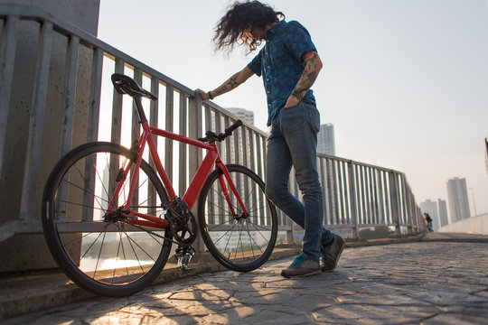 Man standing next to his bicycle