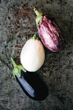 Three types of eggplants on metal background