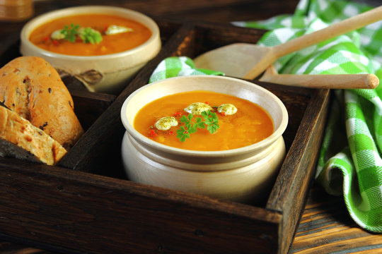 тыквенный крем суп со сметаной в деревянной миске
