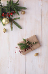 Christmas gift boxes and fir tree branch on wooden table, flat lay. Сhristmas background