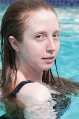 A woman with red hair in below or above the surface.