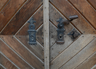 Vintage rusty  door handle on wooden door