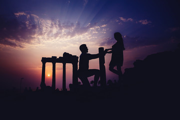 Silhouette of lover backdrop of ancient ruins.