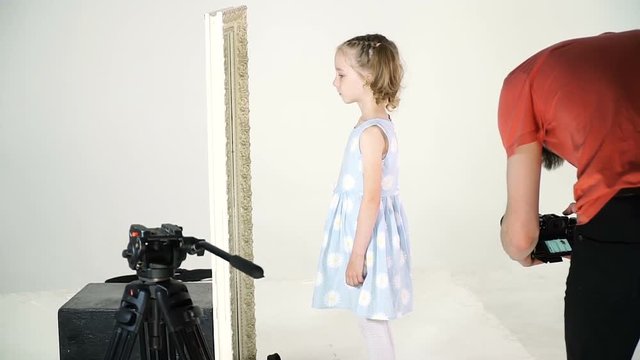 Little girl in the process of video clip shooting