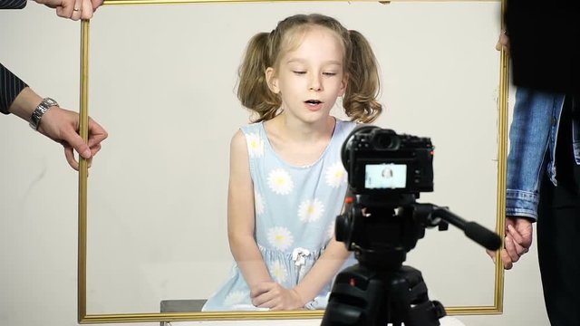 Little girl in the process of video clip shooting