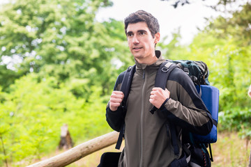 Young hiker in the woods enjoying the view and the experience of nature in wilderness