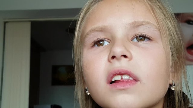 Young girl with one milk tooth