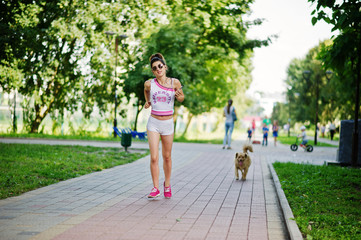 Sport girl wear on white shorts ans shirt running at park.