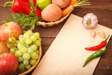 Freshly picked vegetables and fruits in a wooden background basket. Background. Autumn, harvest. Thanksgiving Day. Space for text.
