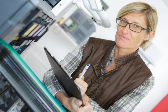 female technician checking printer