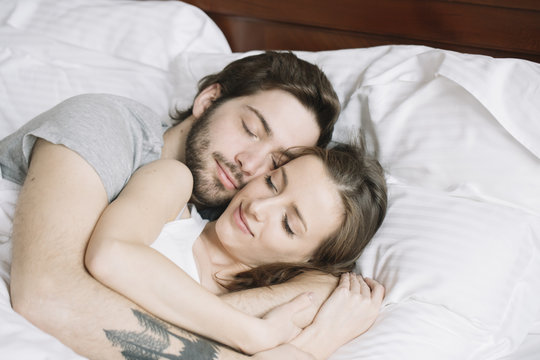Couple sleeping hugging on pillow
