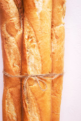 French baguettes with rope from bakery, closeup