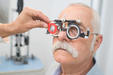 eye specialist determines distance of eyes pupils to patient