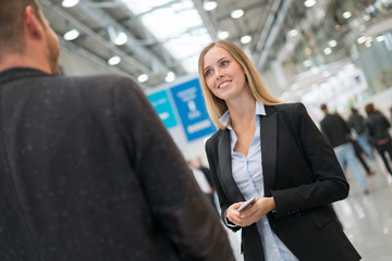 young beautiful businesswoman at a trade fair
