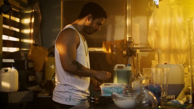 In the Underground Laboratory Hardcore Dealer Places Brick Packs with Drugs Into Suitcase for Further Selling and Distribution. 