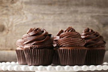 Chocolate cupcakes on white cake stand