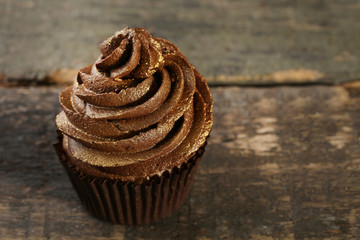 Chocolate cupcake on wooden table