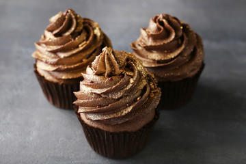 Chocolate cupcakes on grey wooden table