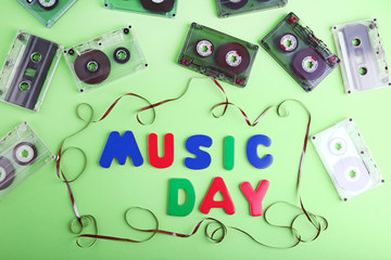 Cassette tapes with inscription Music Day on green background