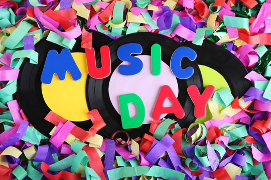 Vinyl records with inscription Music Day on colorful confetti