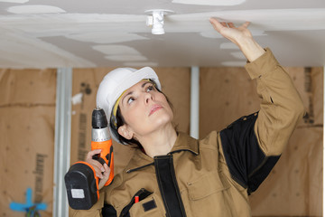 female electrician working in home