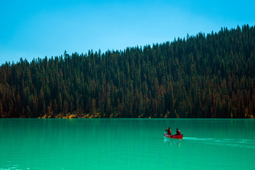 Scenic view of the Lake Louise at Banff National Park with a red canoe 