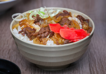 Gyudon traditional japanese food. Slices of meat with onion on the cooked rice. Beef Bowl