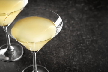 Glasses of lemon drop martini on dark table