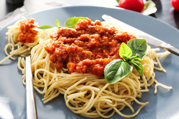 Delicious pasta with bolognese sauce on plate, closeup