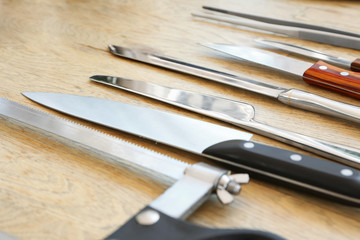 Set of knives on wooden background