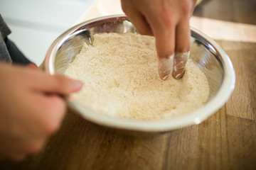 Flour with Hands in Aluminum Bowl