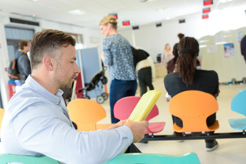 Naklejka premium different people sitting in a waiting room of a hospital