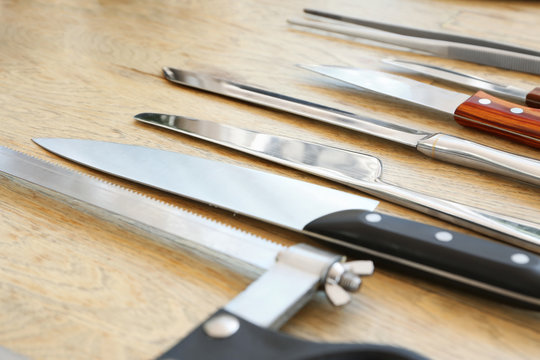 Set of knives on wooden background