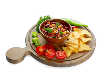 Chili con carne in bowl with chips and vegetables, isolated on white