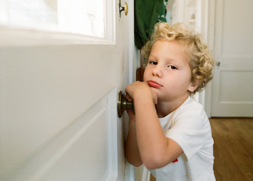 boy leaning on door