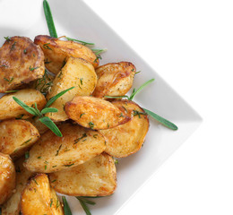 Delicious baked potatoes with rosemary on plate, isolated on white