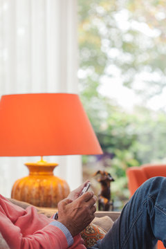 Hands Of An Older Man Texting On His Mobile Phone