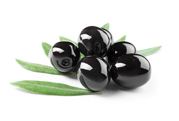 Black olives with leaves, isolated on white