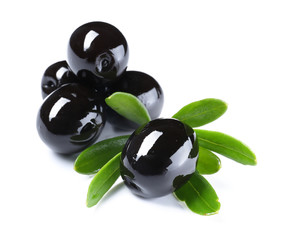 Black olives with leaves, isolated on white