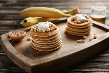 Fototapeta na wymiar Yummy banana pancakes on wooden board